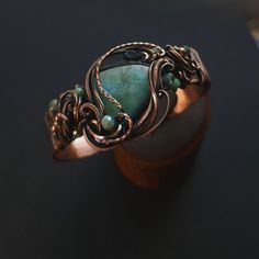 Handcrafted copper cuff bracelet caribbean larimar gemstone, smooth, unique shape, genuine gemstone  london blue topaz teardrop accent  glass & copper accent beads  1/2" wide hand formed copper cuff band, adjustable fit  pure copper wire wrapped, oxidized for an antiqued finish, tumlbed and polished  unique wearable art {ocean inspired} 🌊 comes nicely packaged with a business card, jewelry care instructions and a polishing cloth Copper Bracelets With Natural Stones As Gift, Copper Bracelets With Natural Stones For Gifts, Copper Bracelet With Natural Stones As A Gift, Bronze Gemstone Jewelry, Copper Wire Wrapped Bangle, Adjustable Bronze Gemstone Jewelry, Handmade Amazonite Bracelets As Gift, Elegant Hand Wrapped Copper Jewelry, Bohemian Electroformed Bangle