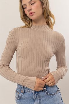 ribbed Mock neck Long Sleeve Fitted Beige Ribbed High Neck Sweater, Beige Ribbed High-neck Sweater, Stretch Ribbed Turtleneck Top, Spring Neutral Colored Turtleneck With Ribbed Cuffs, Solid Color Ribbed Funnel Neck Tops, Ribbed Stretch Funnel Neck Tops, Spring Solid Turtleneck With Ribbed Cuffs, Spring Ribbed Cuff Turtleneck, Stretch Ribbed Funnel Neck Tops