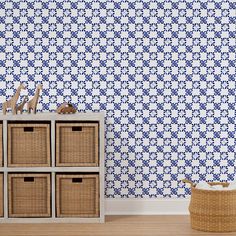 a blue and white wallpaper with baskets in front of it