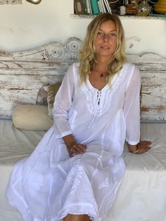 This ibiza style white A shape dress with matching  chickan hand  embroidery all over  - is so beautiful and fresh . you can wear the super soft cotton fabric trough the summer .. its a much loved boho loose fit dress which fits all sizes from small to extra large  .. amazing is all the hand work involved in the indian chikan embroidery. its a unique piece of handwork created for you boho woman   from all over in the world.. love from ibiza  Details: Hand embroidered by artisans in  3/4 sleeves Laced neckline with functional ties Side-seam pockets Double layered so non-see through Super-soft 100% cotton Wash at 30 degrees AUROBELLE  IBIZA.   About the chikan embroidery  The technique of creation of a chikan work is known as Chikankari is a delicate and artfully done hand embroidery on a va White V-neck Embroidered Dress For Festival, White Maxi Dress With Chikankari Embroidery, White Summer Beach Dress For Beach Wedding, White Chikankari Embroidery Maxi Dress, White Summer Beach Wedding Dress, White Cover-up For Beach Wedding, White Chikankari Maxi Dress, White Cotton Beach Dress, White Boho Maxi Dress For Beach Cover-up