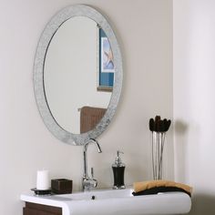 a bathroom sink with a mirror above it and a towel on the counter next to it