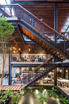 the inside of a restaurant with stairs and tables