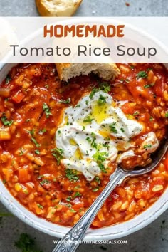 homemade tomato rice soup in a white bowl with bread on the side