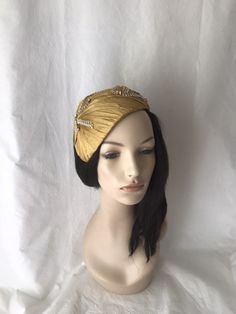 This vintage inspired gold pleated silk dupioni half hat fascinator with gold and silk rhinestone trim. This gold headpiece is perfect to wear as a bridal Juliet Cap, women's formal church hat, derby style tea parties, mother of the bride hat, wedding guest hat or any other special occasion. Please note this is handmade by order and so the pleating maybe slightly different from the one shown. We pride ourselves on making sure you receive a beautifully designed headpiece that's truly yours. Easy Gold Gatsby Style Formal Headpieces, Vintage Gold Headpiece For Evening, Gold Gatsby Headpiece For Vintage Events, Gold Gatsby Evening Headpieces, Gold Gatsby Headpieces For Evening, Elegant Gold Hat For Evening, Elegant Gold Evening Hats, Gatsby Style Evening Fascinator Headband, Elegant Fascinator For Vintage Events