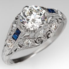 an antique style diamond and sapphire engagement ring