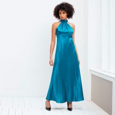 Make a statement with our silk dress in a striking teal hue. Featuring a high-collared neckline, mid-length skirt and a beautiful fit creating a beautiful silhouette. Perfect for weddings, cocktails and holiday occasions. Complement with sandals and a bold earring for an elegant look. This look is the quintessential ready-to-wear item in any coveted wardrobe. Composition: 100% SilkCare: Dry clean only Luxury Green Silk Evening Dress, Elegant Green Halter Dress For Formal Occasions, Elegant Green Halter Dress For Evening, Elegant Green Halter Evening Dress, Chic High Neck Silk Midi Dress, Chic Turquoise Fitted Dress, Elegant Sleeveless Midi Dress In Turquoise, Elegant Turquoise Sleeveless Midi Dress, Fitted Turquoise Midi Dress For Party