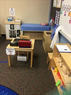 a room filled with lots of wooden furniture and toys on the floor next to bookshelves