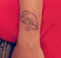 a small tattoo on the wrist of a woman's arm that has a baby elephant in it