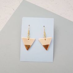 A pair of pink glazed porcelain triangle dangle earrings with 22k gold lustre detail. Ear posts are gold plated hypoallergenic fish hooks for pierced ears. They will be supplied with clear rubber stoppers.The porcelain triangles are fired 3 times to achieve this finish and are very lightweight and durable. Please note the earrings are only glazed on one side due to the nature of the process. The back will be the pure white of the porcelain.The triangles measure approx 2.5cm wide x 2cm high and w White Triangle Earrings For Gift, Pink Triangular Jewelry For Gifts, Pink Triangle Jewelry For Gifts, Pink Triangle Jewelry For Gift, Gold Triangle, Fish Hooks, Earrings Geometric, Triangle Earrings, Round Stud Earrings