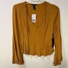 Forever 21 Deep V-Neck And Bell Sleeves Mustard Colored Top Nwt Brand New Forever 21 Top. Size Small. Color Is Mustard/Yellow. Zipper On Side: Trendy Fitted V-neck Top For Fall, Trendy Summer V-neck Top For Work, Fall V-neck Top For Day Out, Trendy V-neck Blouse For Date Night, Forever 21 Tops For Fall Date Night, Fall V-neck Top For Date Night, Forever 21 V-neck Workwear Tops, Mustard Retro Long Sleeve Tops, Mustard V-neck Top For Beach