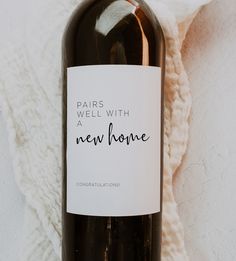 a bottle of wine sitting on top of a white blanket