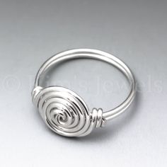 This ring is uniquely hand-crafted with 18 gauge sterling silver round wire, and is approximately 10mm in diameter. I make this ring to order. The ring pictured is a representation of what you will receive. **The photos make the rings look much larger than they actually are.** Silver Spiral Wire Wrapped Rings, Minimalist Silver Wire-wrapped Rings, Minimalist Sterling Silver Wire Wrapped Rings, Minimalist Silver Wire Wrapped Rings, Wire Wrapped Round Ring For Promise, Minimalist Spiral Sterling Silver Ring, Minimalist Sterling Silver Spiral Ring, Spiral Stackable Sterling Silver Rings For Gift, Spiral Stackable Sterling Silver Rings As Gift