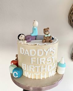 there is a cake that says daddy's first birthday with two small bears on top