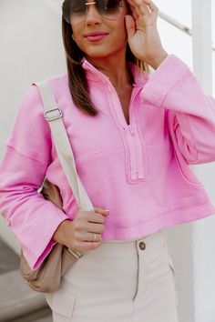 "The ZIP COZY CROP SWEATSHIRT is the ultimate combination of style and comfort. The defined collar provides a sleek look while the long drop-shoulder sleeve offers a relaxed fit. With a convenient half-zip neckline and kangaroo pocket, this sweatshirt is perfect for all-day wear. Stay cozy and stylish with this must-have piece." Pink Sweatshirt With Ribbed Collar For Spring, Spring Half-zip Loungewear Sweater, Spring Half-zip Sweater For Loungewear, Trendy Oversized Half-zip Top, Pink Half-zip Sweatshirt For Fall, Pink Half-zip Top For Fall, Trendy Half-zip Top With Ribbed Cuffs, Pink Ribbed Collar Tops For Loungewear, Pink Tops With Ribbed Collar For Loungewear