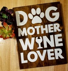 a wooden sign that says dog mother whine lover on it next to a succulent