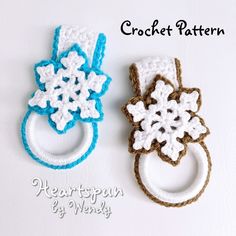 two crocheted rings with snowflakes on them, one is white and the other is blue