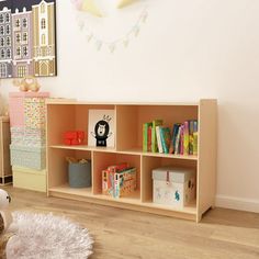 a child's room with toys and bookshelves on the floor, including a teddy bear