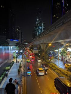 the city street is busy with traffic at night