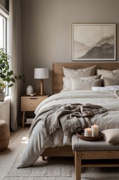 a bedroom with a large bed covered in blankets and pillows