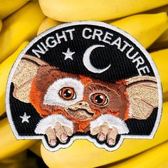 a patch with an image of a cat on it and some bananas in the background