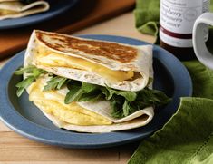 there is a plate that has two quesadillas on it, one with eggs and spinach