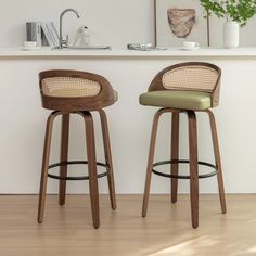 two wooden stools sitting next to each other on top of a hard wood floor