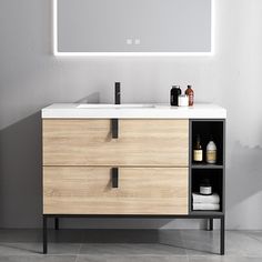 a bathroom vanity with two drawers and a large mirror above it, in front of a white wall