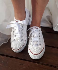 the bride's shoes are all white and have red trimmings on them