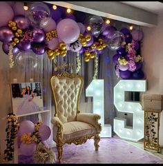 a room with balloons, lights and a chair