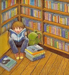 a child is sitting on the floor reading a book in front of bookshelves