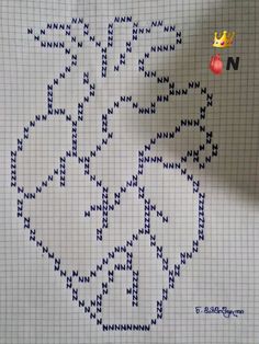 a cross - stitch pattern is shown on a piece of paper that has been drawn