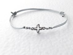 Cross Anklet bracelet cord adjustable size Best choice for birthday, anniversary, holidays, stocking stuffers, graduation and any other occasion. MATERIAL Silver Plated Charm Cross Charm Metal - Brass ( Lead and Nickel Free) 100% Nylon Multiple Cord Easy to put on and adjust with the adjustable sliding closure. For ANKLET length cord is approximately 36 cm/ 14 inches ( ONE SIZE ) For BRACELET length cord is approximately 28 cm/ 11 inches ( ONE SIZE ) Please select a bracelet or an anklet ------- Minimalist Adjustable Bracelets For Birthday, Minimalist Adjustable Bracelet For Birthday, Adjustable Clasp Bracelet With Waxed Cord As Gift, Adjustable Waxed Cord Bracelet As Gift, Silver Braided Bracelet With Adjustable Length As Gift, Adjustable Braided Bracelets For Birthday, Adjustable Waxed Cord Bracelet For Gift, Adjustable Spiritual Friendship Bracelets For Birthday, Adjustable Waxed Cord Bracelet Gift