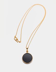 The black mirror is a symbol of our times. We live in a world of black, shiny surfaces, behind which there is a parallel, yet unrecognized reality.Necklace with a natural, black stone, onyx, made of 925 silver optional plated with 24-carat gold. It has a special hook and eye clasp. Diameter: 27 mm, height: 42 mm, thickness: 4 mm. Chain length: 600 mm.The product is made entirely in Poland. Possible chain length personalization on request. Waiting time up to 20 business days. Write a message what