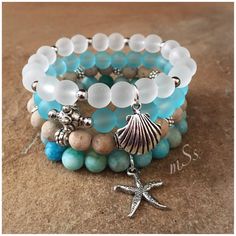 "Electic, boho chic stretch bracelet stack of four featuring 8mm beads of blue and white beach glass, matte beige and blue mix agate with silver tone accents, spacer beads and 2 beach-inspired charms.  One is a sea shell and the other a starfish. Versatile. Wear all or one at a time and pair with your other jewelry.  Stretch Bracelets Sized for a 7 \" wrist  mSs Distinctive Designs Studio Home Page: http://www.etsy.com/shop/mSsDDesigns  CUSTOM ORDERS ARE WELCOME I have access to a variety of gem Beach Themed Beaded Bracelets, Sea Inspired Bracelets, Beach Theme Jewelry, Boho Bracelets Diy, Blue Gemstone Bracelet, Memory Wire Jewelry, Organizing Hair Accessories, Bracelets Beaded, Studio Home