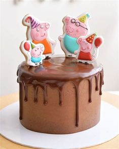 a chocolate cake topped with pep the pig characters