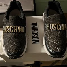 Black And Gold Moschino Glitter Logo Sneakers Eu Size 32. Never Worn. Box Included Glitter Accent Sneakers For Streetwear With Round Toe, Glitter Accented Sneakers For Streetwear With Round Toe, Glitter Accents Sneakers For Streetwear With Round Toe, Black Low-top Party Sneakers, Trendy Party Sneakers With Glitter Print, Sporty Round Toe Sneakers For Party, Sporty Party Sneakers With Round Toe, Party Sneakers With Glitter Print And Round Toe, Black Low-top Sneakers For Parties