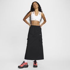 Find NIKE Sportswear Essential Mid-rise Woven Cargo Midi Skirt on Editorialist. Midi or mini? A zipper above the pockets on this loose-fitting ripstop skirt makes choosing easier. A bungee at the bottom hem gives you even more styling options. Benefits:Elastic waistband gives you comfortably snug fit. Pockets provide quick storage for keys, phone and cold hands. Product Details:52% polyester/48% cotton. Embroidered Swoosh logo on left thigh. Hidden snaps on cargo pockets. Machine wash. Imported. Sporty Black Pleated Skirt, Sporty Nike Skirt For Spring, Casual Nike Sports Skirt, Nike Casual Sports Skirt, Sporty Skirt For Sports, Sporty Skirt For Spring Sports, Sporty Nike Skirt For Sports, Nike Activewear With Pockets For Streetwear, Sporty Moisture-wicking Skirt