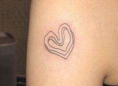 a small tattoo on the back of a woman's left arm, depicting two intertwined hearts