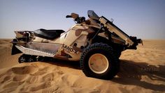 an off - road vehicle in the desert on sand