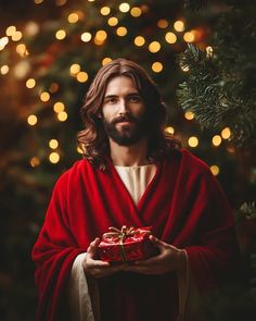 jesus holding a gift in front of a christmas tree