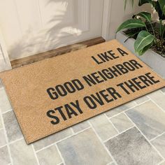 a door mat that says, like a good neighbor stay over there