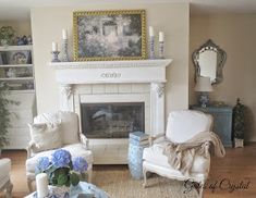 a living room filled with furniture and a fire place in front of a painting on the wall