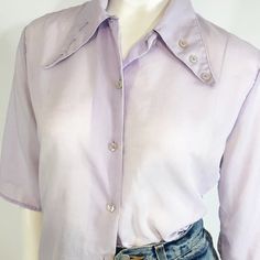 Vintage cotton lilac button up with jumbo pointed collar and button detail. Pit stains and other various light stains on material, missing last button  Made in USA  𝑆𝑖𝑧𝑒 M 𝐴𝑙𝑙 𝑖𝑡𝑒𝑚𝑠 𝑎𝑟𝑒 𝑚𝑒𝑎𝑠𝑢𝑟𝑒𝑑 𝑙𝑎𝑦𝑖𝑛𝑔 𝑓𝑙𝑎𝑡, 𝑓𝑟𝑜𝑛𝑡 𝑜𝑛𝑙𝑦 𝑎𝑛𝑑 𝑎𝑟𝑒 𝑎𝑝𝑝𝑟𝑜𝑥𝑖𝑚𝑎𝑡𝑒: Chest/ pit to pit: 18" Length: 22" Sleeve length: 12.5 ☯︎ ☯︎ ☯︎︎ ☯︎︎ ☯︎︎ ☯︎︎ ☯︎︎ ☯︎︎  #vintage #retro #bigcollar #lilac Collared Shirt With Snap Buttons For Daywear, Purple Button-up Blouse For Daywear, Vintage Cotton Blouse With Collared Neckline, Purple Top With Spread Collar And Button Closure, Vintage Purple Tops With Buttons, Vintage Collared Button Tops, Vintage Collared Blouse With Placket, Purple Short Sleeve Blouse With Buttons, Vintage Collared Neckline Tops With Buttons