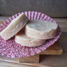 two pieces of shortbread sitting on top of a red and white plate