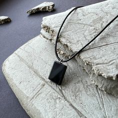 This black oxyn bar gemstone necklace for men by Valeno is a sleek and stylish addition to any outfit.   The necklace features a black cord necklace that is 24 inches long and an adjustable chain that is 5 inches of stainless steel.  The minimalist design of the necklace makes it versatile and easy to pair with any outfit.  The necklace is handmade and comes wrapped in a small suede bag, making it the perfect gift for any man.  The black oxyn bar gemstone adds a touch of elegance and sophisticat Birthday Gift For Husband, Black Cord Necklace, Suede Bag, Gemstone Pendant Necklace, Jewelry Birthday, Necklace Minimalist, Gift For Husband, Necklace For Men, Gemstone Necklace Pendant