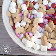 a white bowl filled with marshmallows and hearts