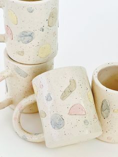 three coffee mugs sitting next to each other