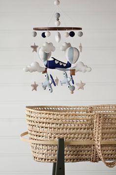 a baby crib with a toy airplane hanging from it