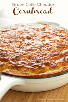 green chile cheddar cornbread in a white dish on a wooden table with text overlay