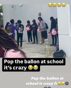 a group of people standing around each other with balloons in front of them and the caption pop the balloon at school